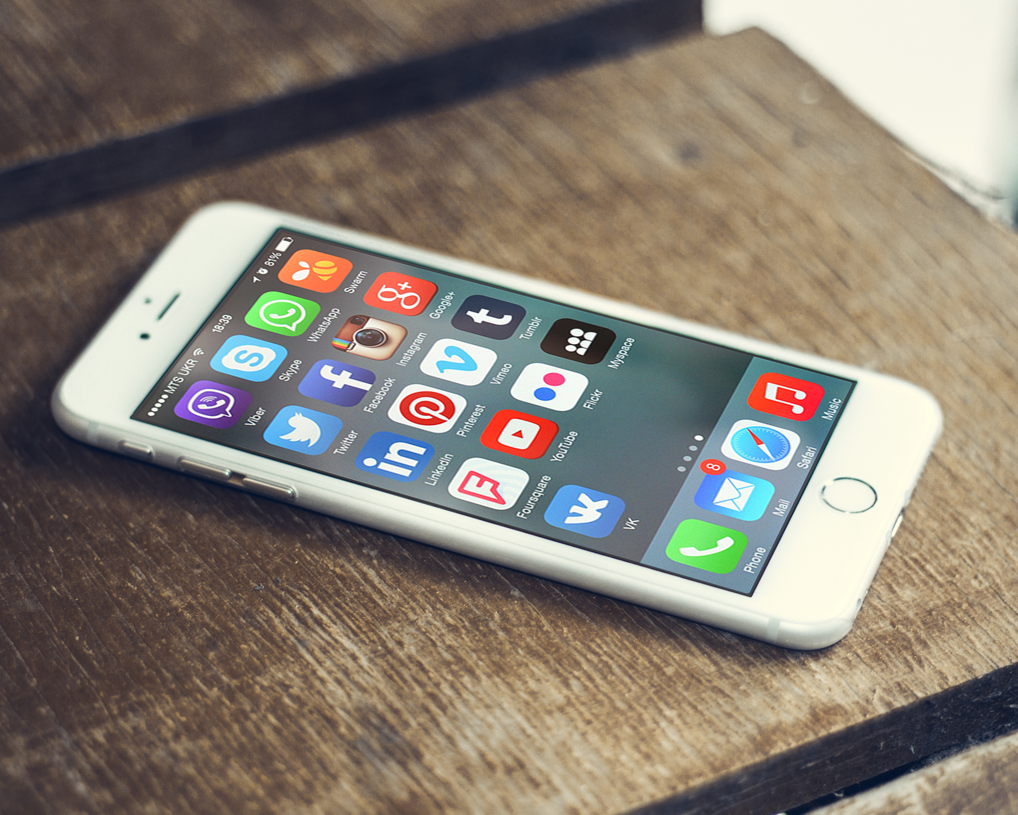 Social media app icons on the screen of a smartphone